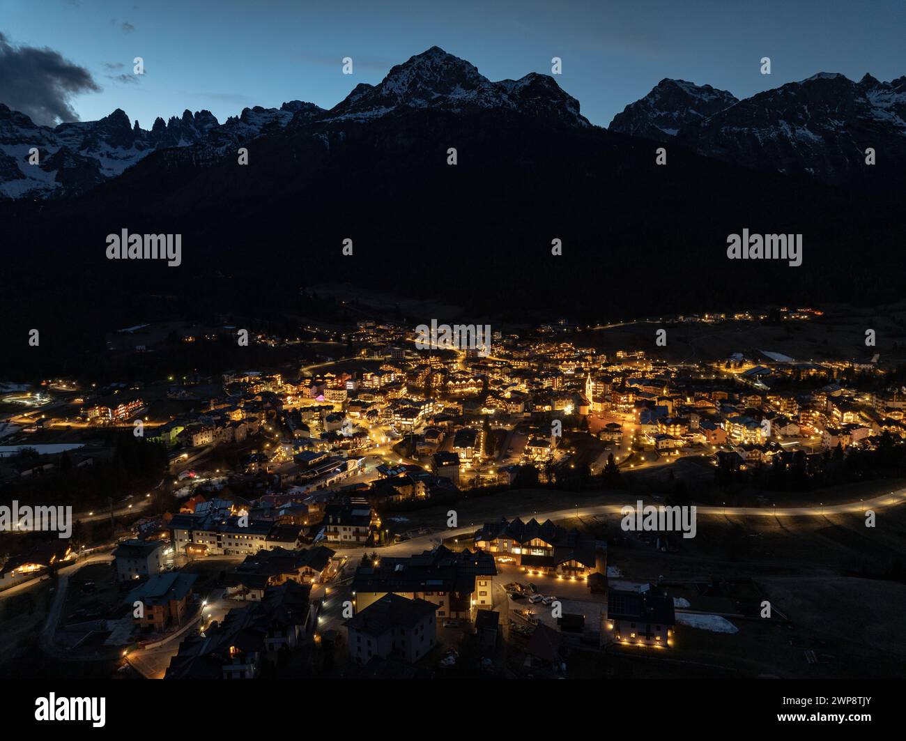 Aerial drone view of Andalo town at night  with mountains background in winter. Ski resort Paganella Andalo, Trentino-Alto Adige, Italy., Italian Dolo Stock Photo
