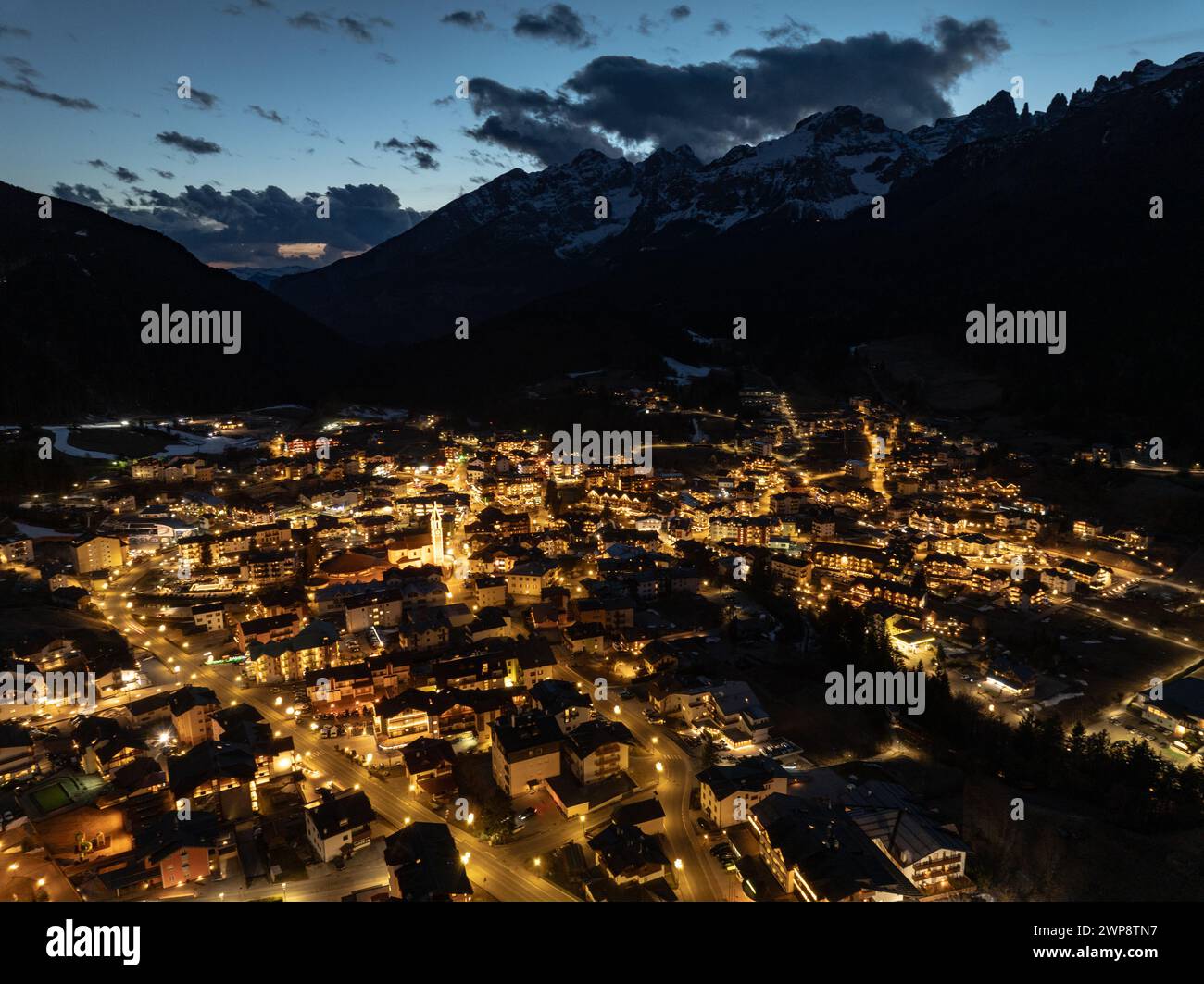 Aerial drone view of Andalo town at night  with mountains background in winter. Ski resort Paganella Andalo, Trentino-Alto Adige, Italy., Italian Dolo Stock Photo