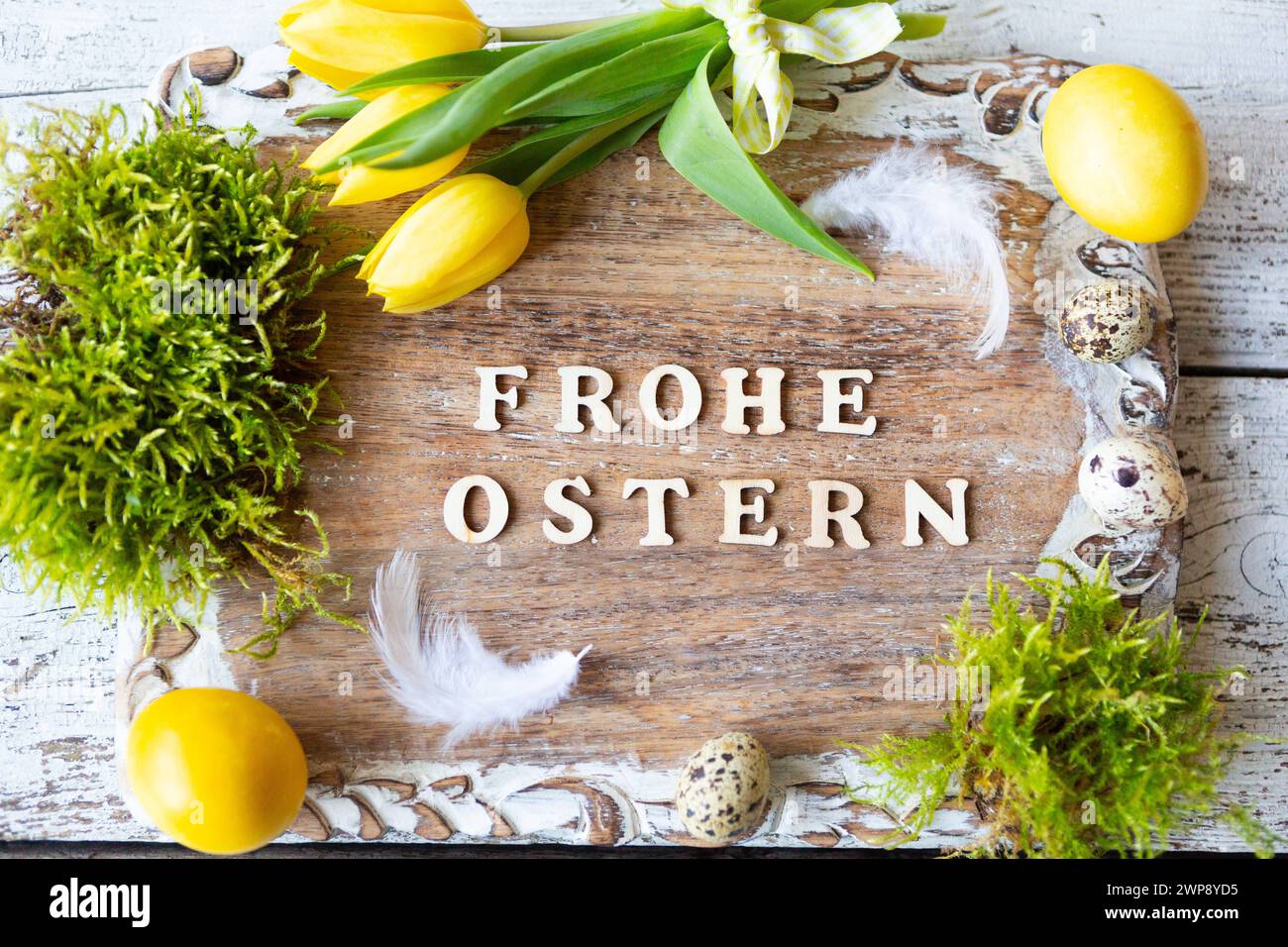 3 March 2024 Happy Easter, greeting on a wooden sign surrounded by