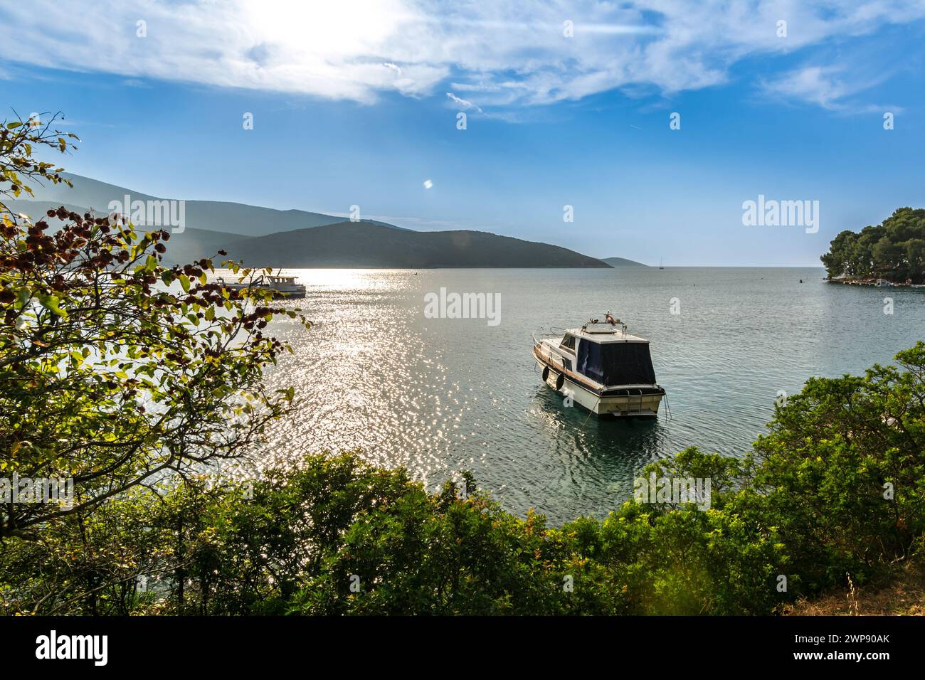 Boat anchoring in a beautiful bay (Osor) on the island of Cres-Losinj in the Adriatic Sea, Croatia Stock Photo