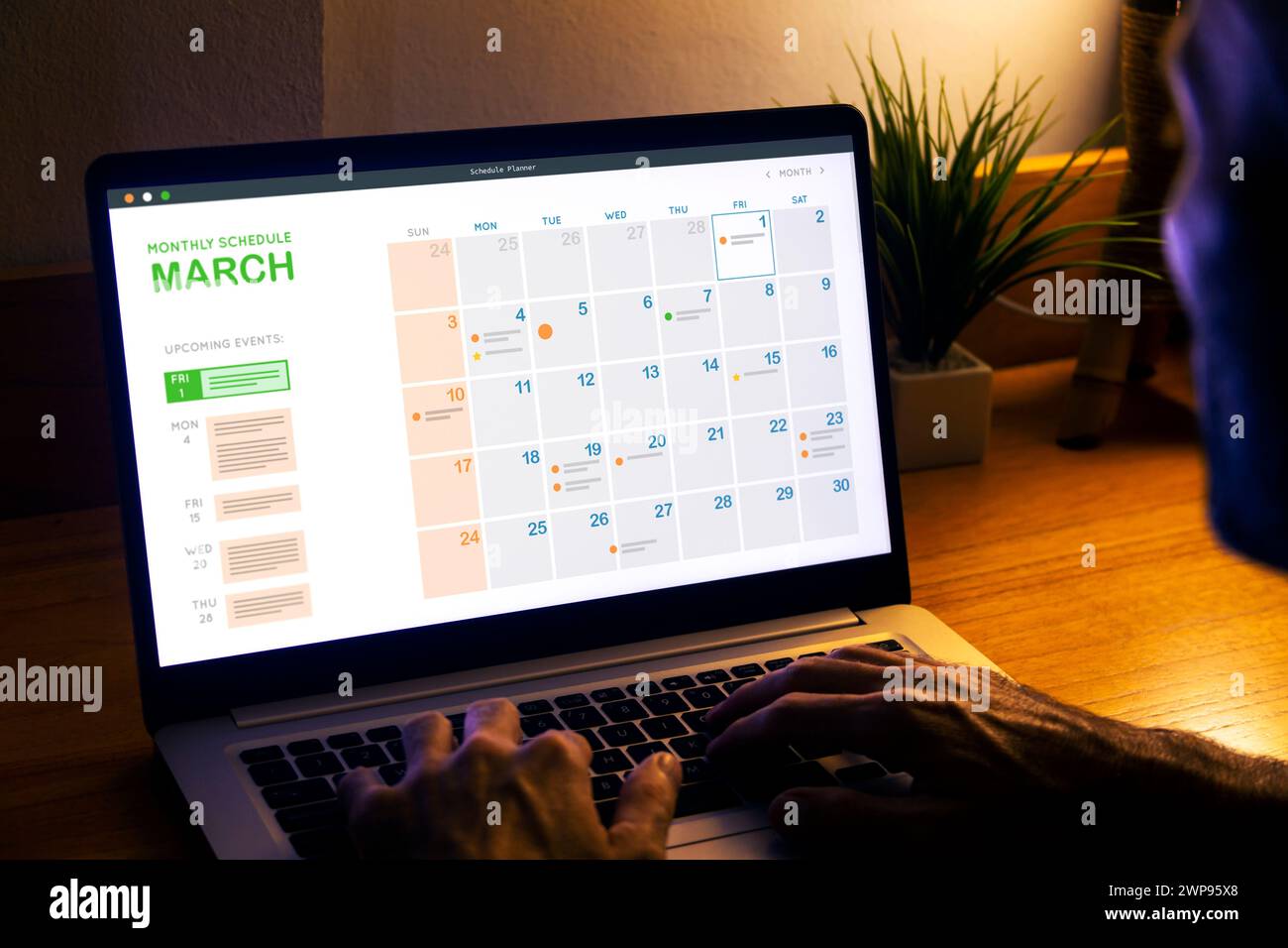 Monthly planner schedule man looking at digital calendar on laptop