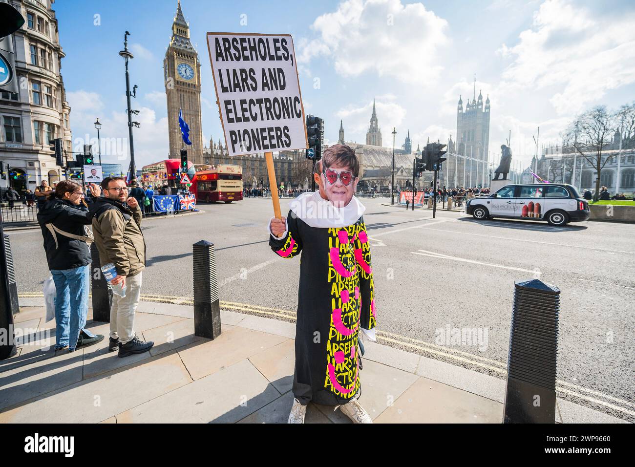 London, UK. 6th Mar, 2024. Arseholes, Liars and Elecronic Pioneers, a one man protest by the Band Paranoid London in and Elton John Mask - Protesters gather outside as Jeremy Hunt MP, Chanceellor of the Exchequer delivers the Budget in Parliament on Budget day in Westminster, London. Credit: Guy Bell/Alamy Live News Stock Photo