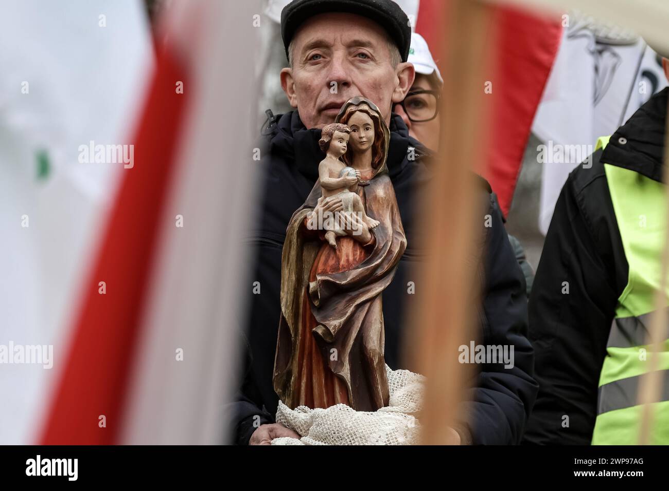 A Polish farmer takes to the streets of Warsaw with a figurine of Saint Mary to protest against EU Green Deal and an import of agricultural goods from non-EU countries, including Ukraine, in front of Prime Minister Cancellary in the centre of Warsaw, the capital of Poland on March 6, 2024. Stock Photo