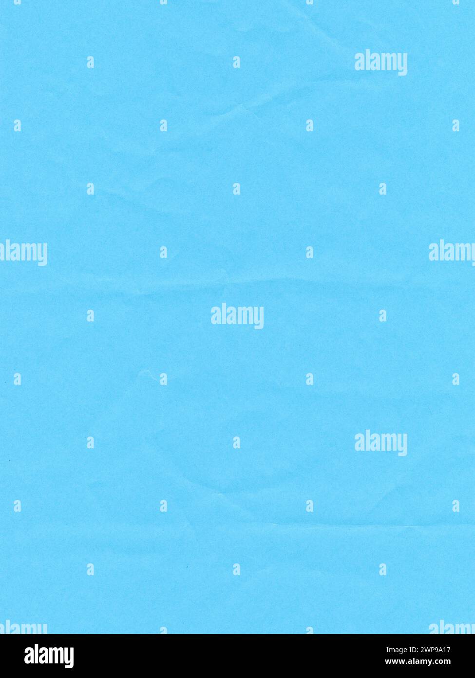 Texture of colored paper, surface of a crumpled light blue sheet of paper Stock Photo