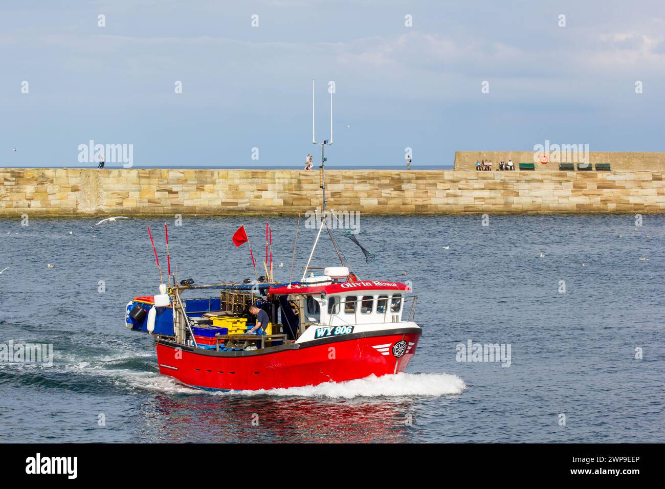 Fishing boats arriving in Whitby harbour Stock Photo - Alamy