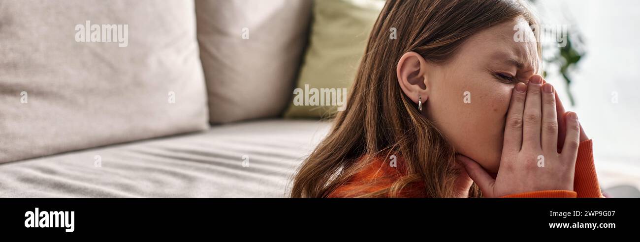 Teenage girl in distress, covering face with hands while crying near ...