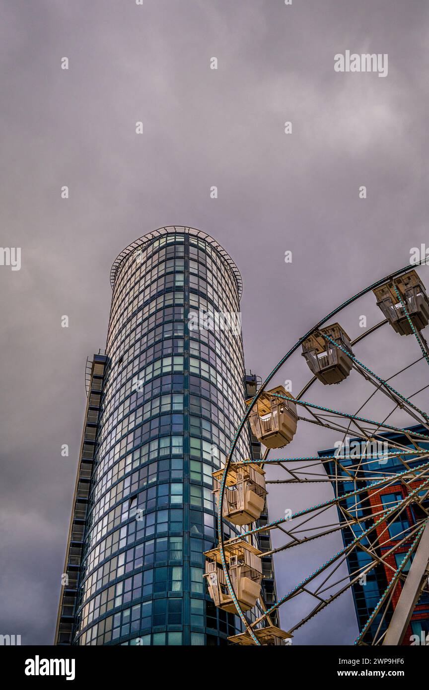 A view of a high rise, glass apartment building, known as the lipstick