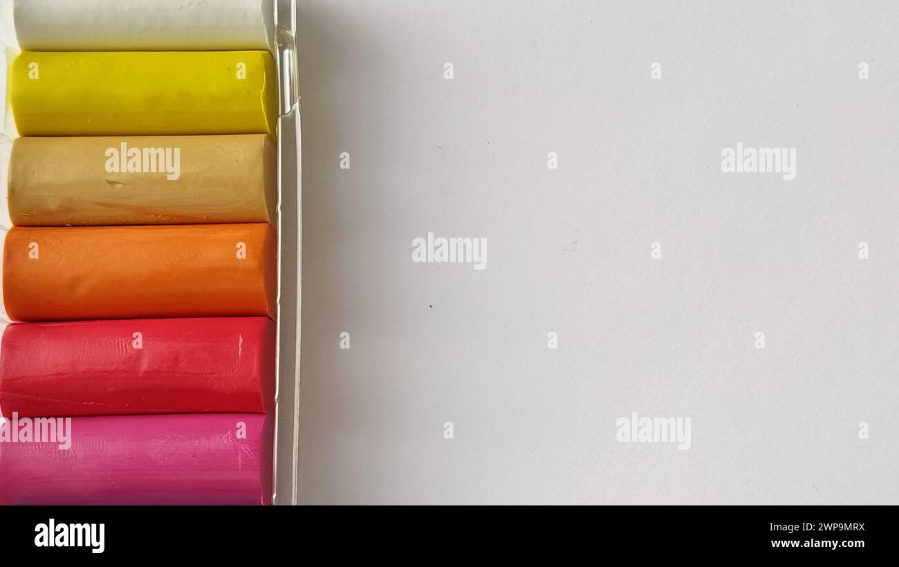 Multi-colored plasticine in plastic packaging on a white background Stock Photo