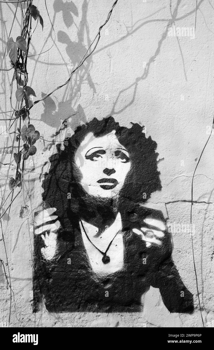 Lisbon, Portugal - April 23, 2015: Graffiti portrait of Fado singer Amalia Rodrigues, known as 'Queen of Fado', on old house wall. Black white photo. Stock Photo