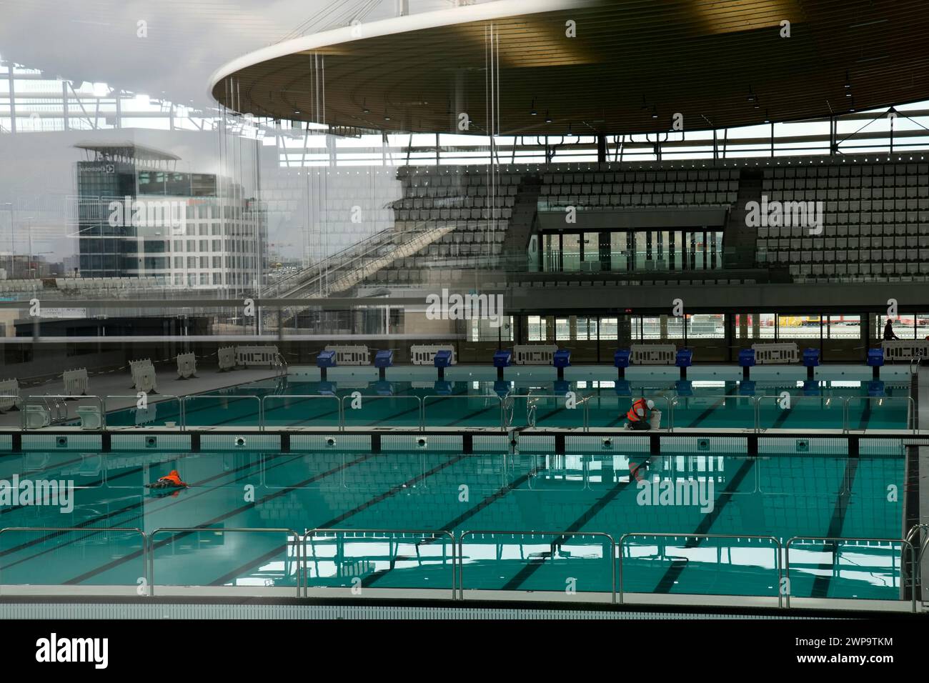 the-stade-de-france-stadium-is-reflected-on-the-window-of-the-olympic