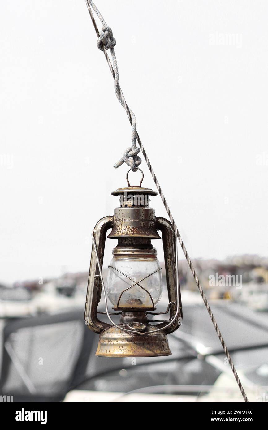 Kerosene lantern hanging from a wire on a sailboat Stock Photo