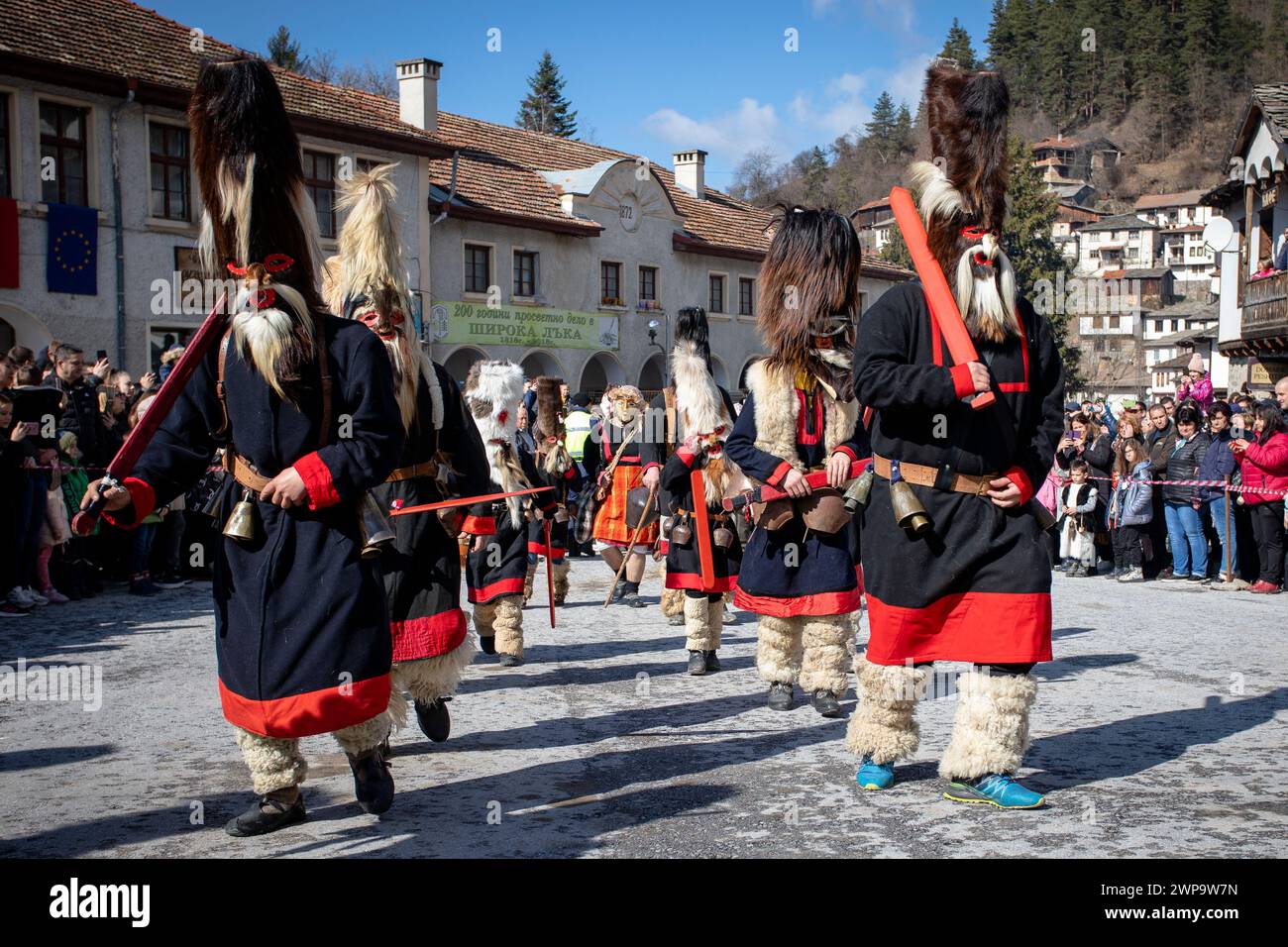 Shiroka Laka, Bulgaria - March 03, 2024: Masked men called Kukeri play and scare away evil spirits at the Pesponedelnik Masquerade Games Festival in S Stock Photo