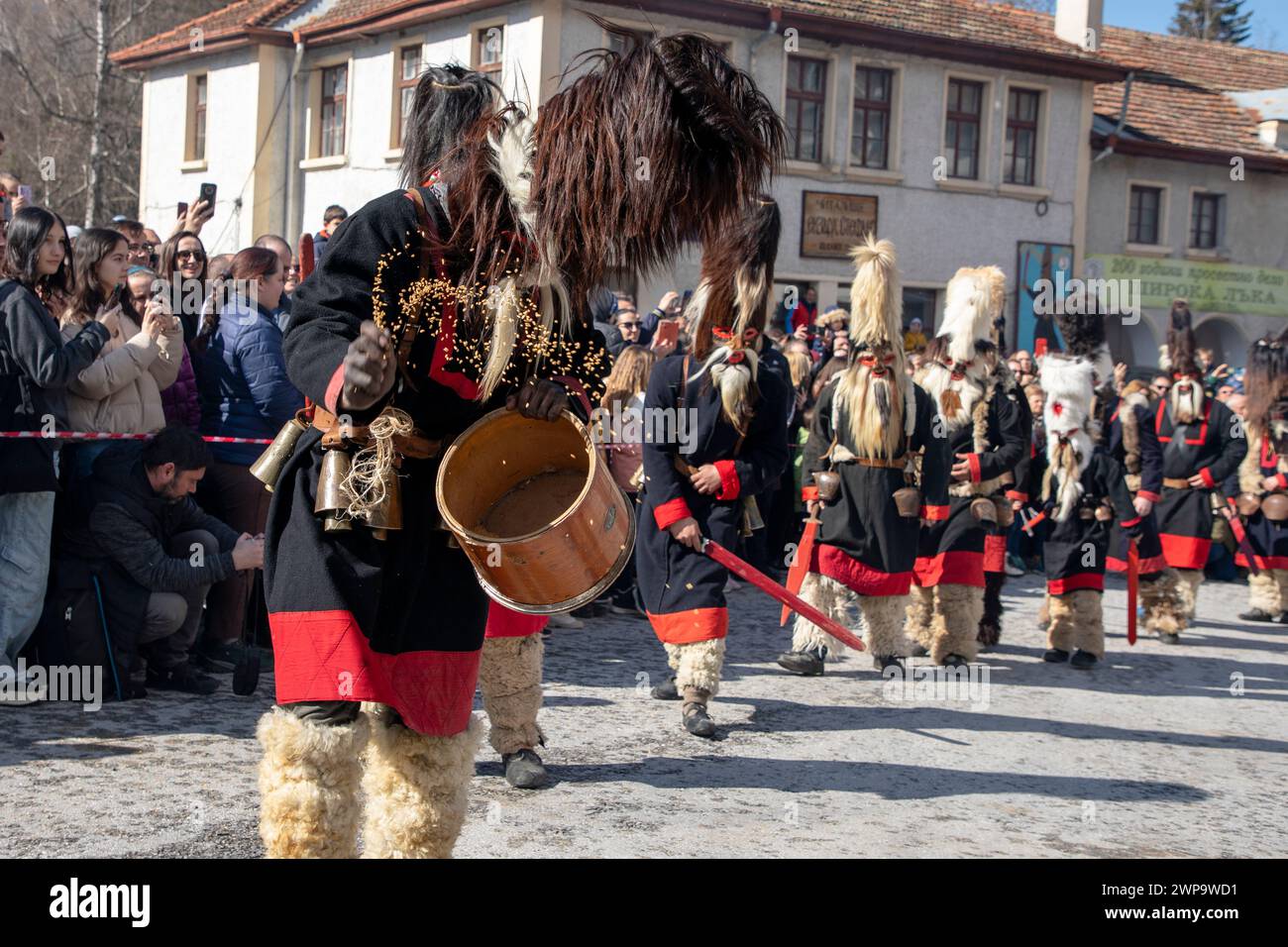 Shiroka Laka, Bulgaria - March 03, 2024: Masked men called Kukeri play and scare away evil spirits at the Pesponedelnik Masquerade Games Festival in S Stock Photo