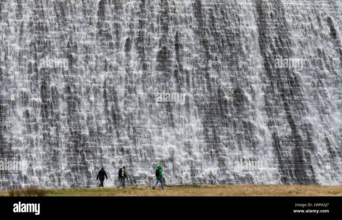 07/01/2014  After days of heavy rain, walkers are dwarfed by a wall of water as it overflows from the Derwent Reservoir over the Derwent dam in The De Stock Photo