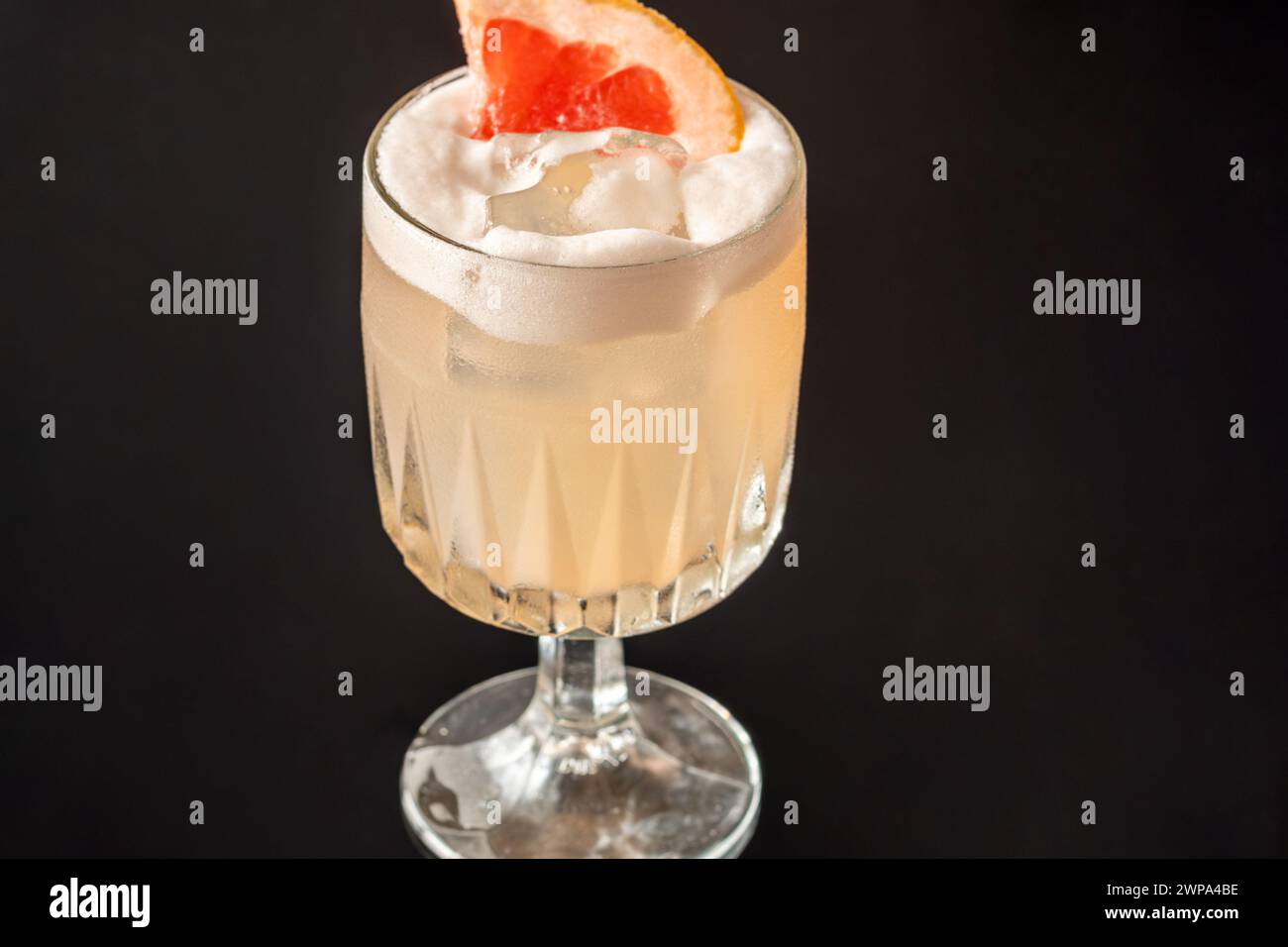 Goblet glass of Grapefruit tequila sour cocktail Stock Photo