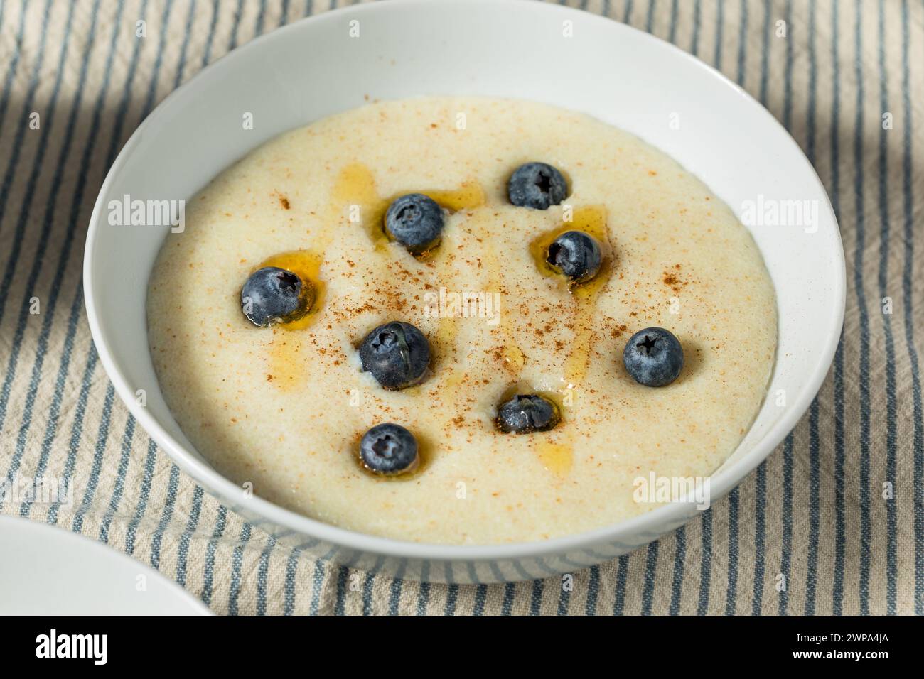 Traditional Healthy Breakfast Wheat Porridge with Honey and Berries Stock Photo