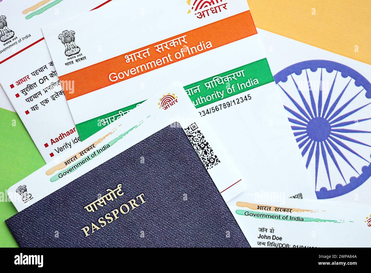 Indian Aadhaar card from Unique Identification Authority of India and Passport on Indian flag close up Stock Photo