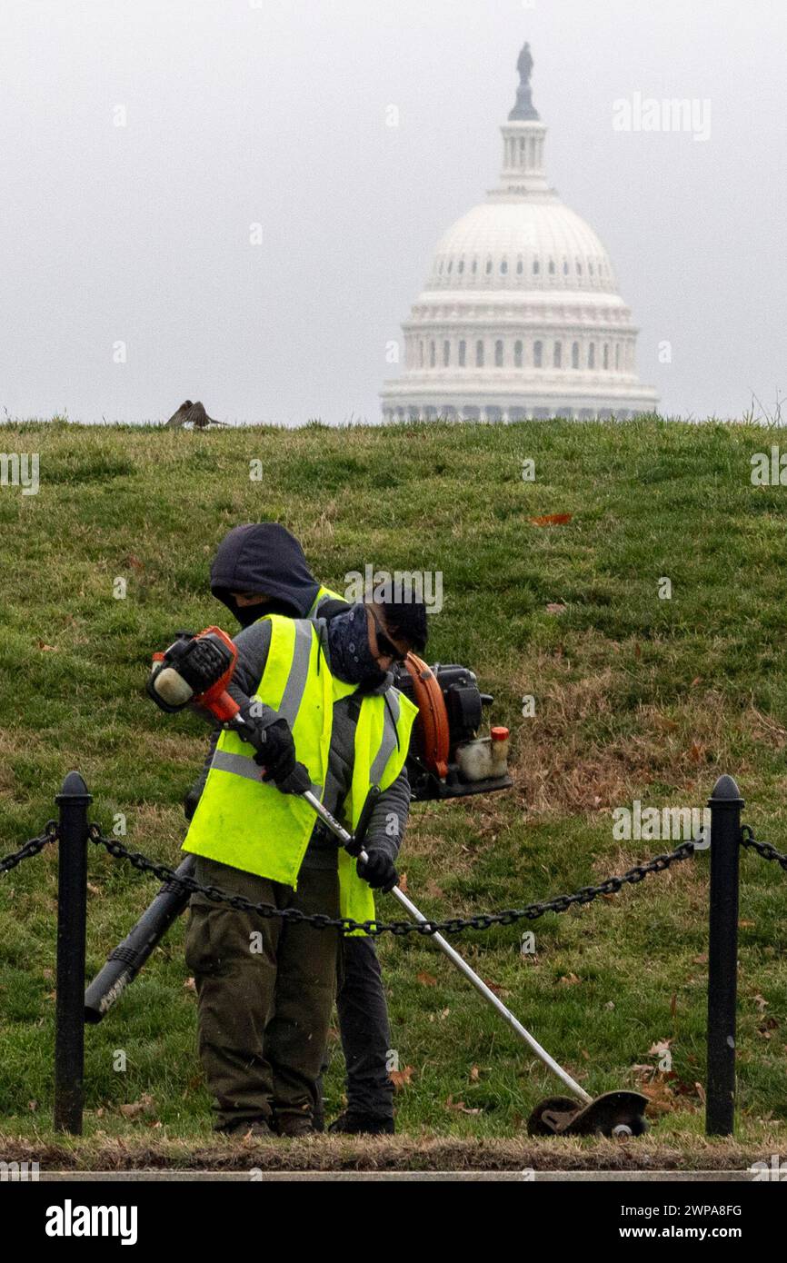 Washington, District Of Columbia, USA. 6th Mar, 2024. Men maintain the National Mall with the United States Capitol in the background Wednesday, March 6, 2024 in Washington, DC (Credit Image: © Eric Kayne/ZUMA Press Wire) EDITORIAL USAGE ONLY! Not for Commercial USAGE! Stock Photo