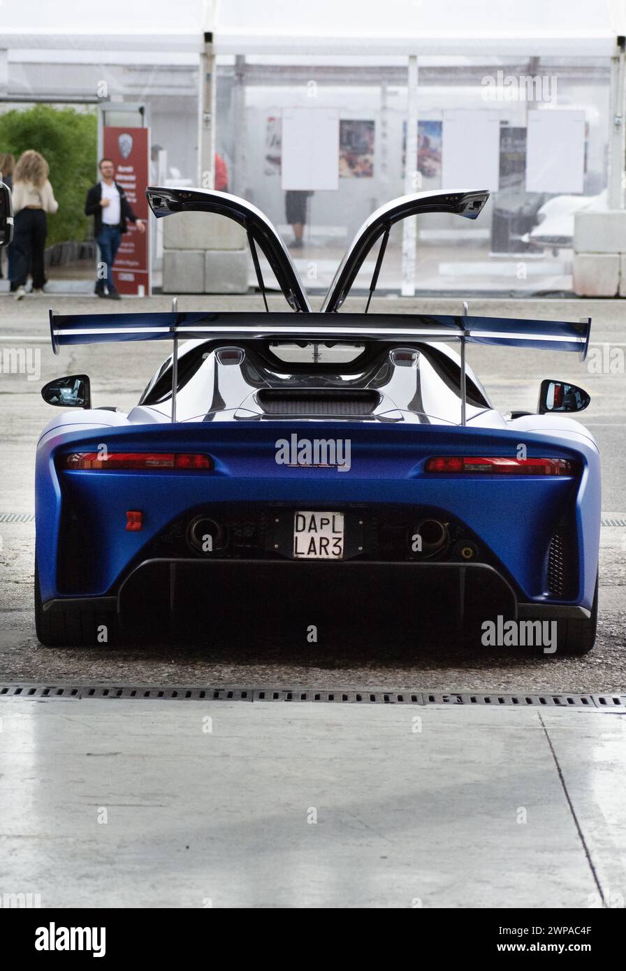 A Blue and black race car with open trunk viewed from the rear Stock Photo