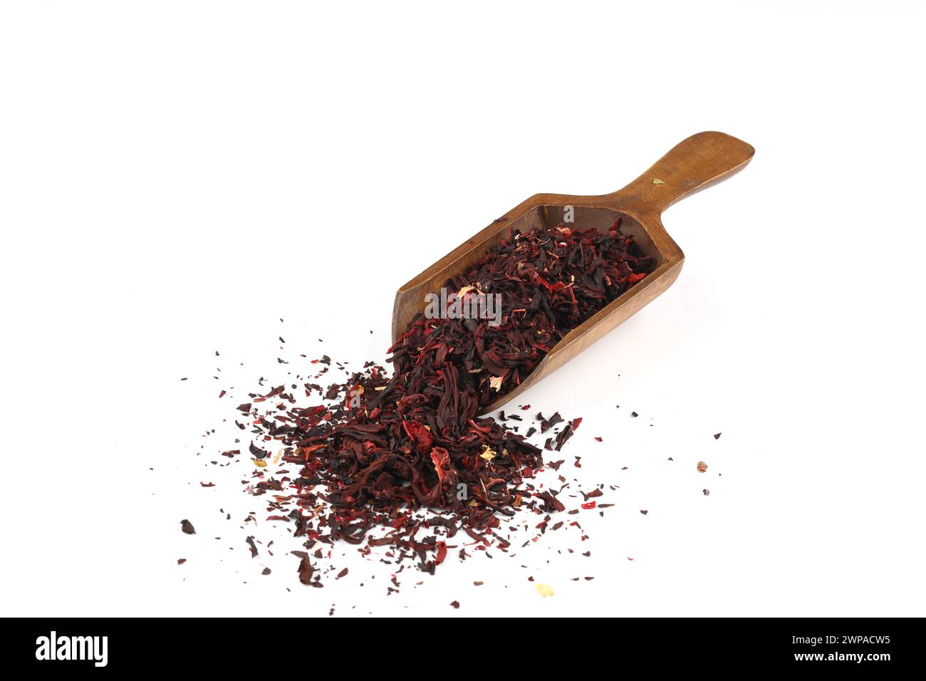Karkade tea. Hibiscus tea leaves in wooden scoop isolated on white background. File contains clipping path. Top view. Stock Photo