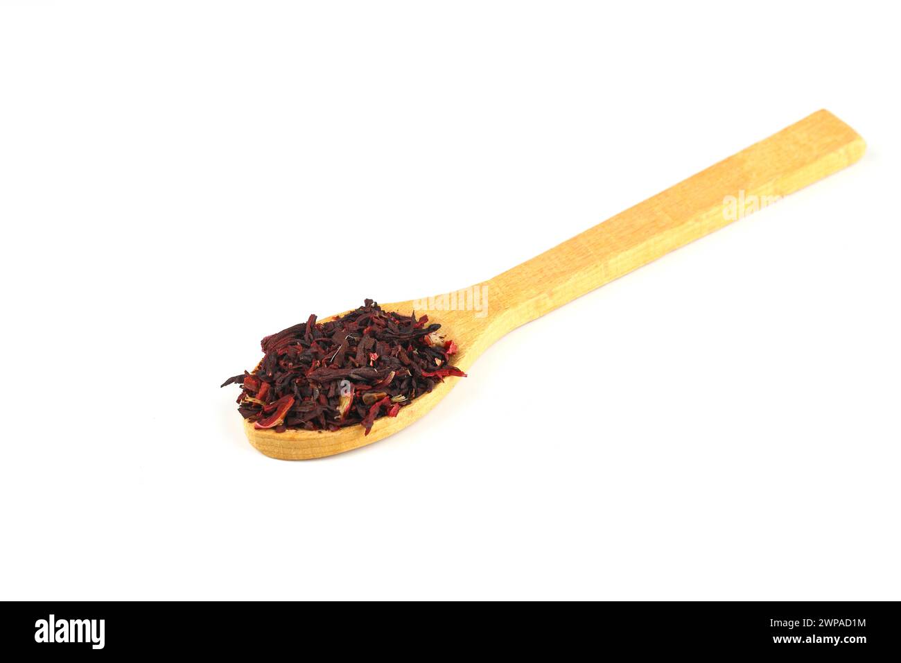 Karkade tea. Hibiscus tea leaves in wooden spoon isolated on white background. File contains clipping path. Top view. Stock Photo