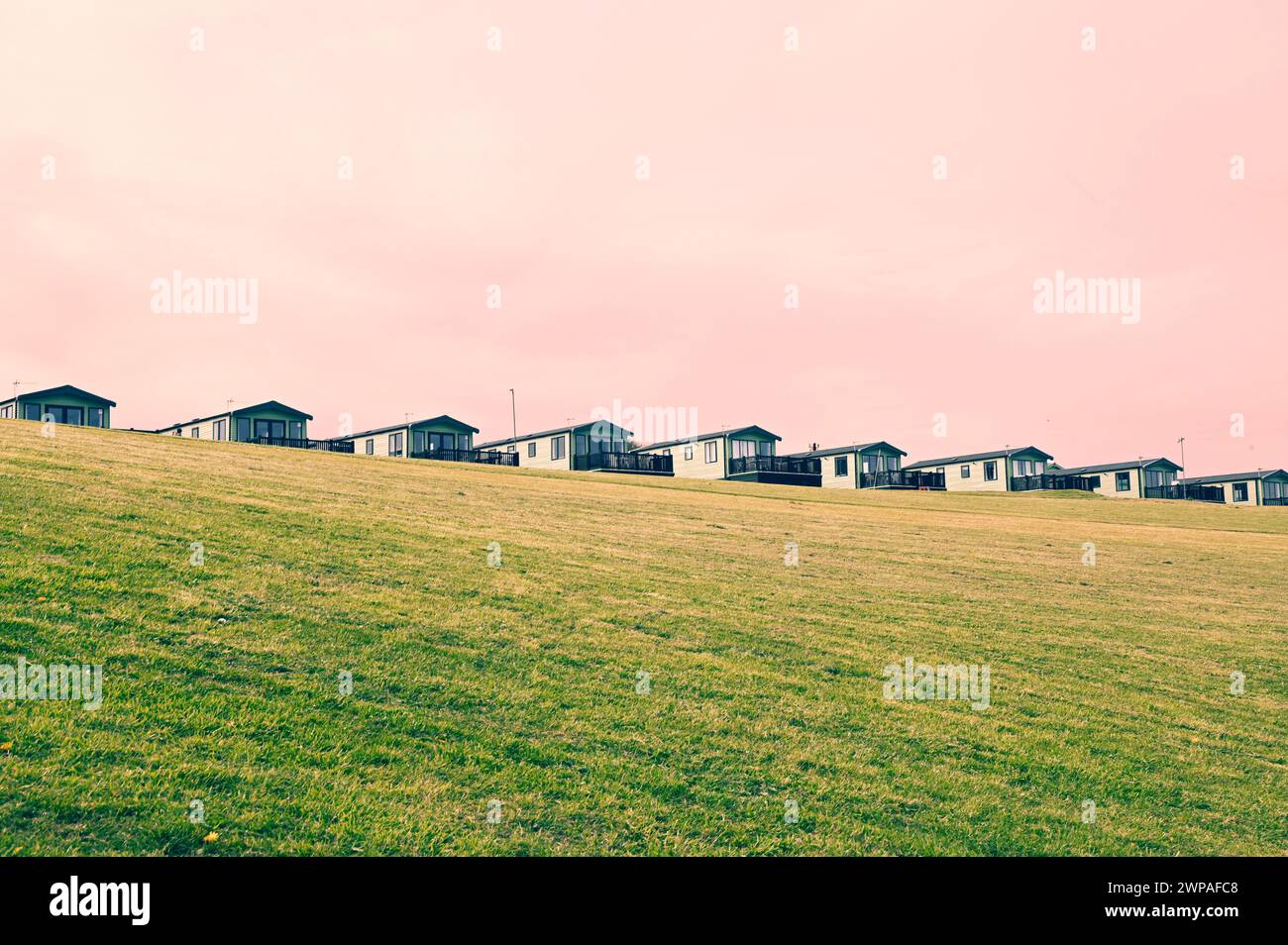 A row of caravans on a minimalist landscape in Cornwall Stock Photo