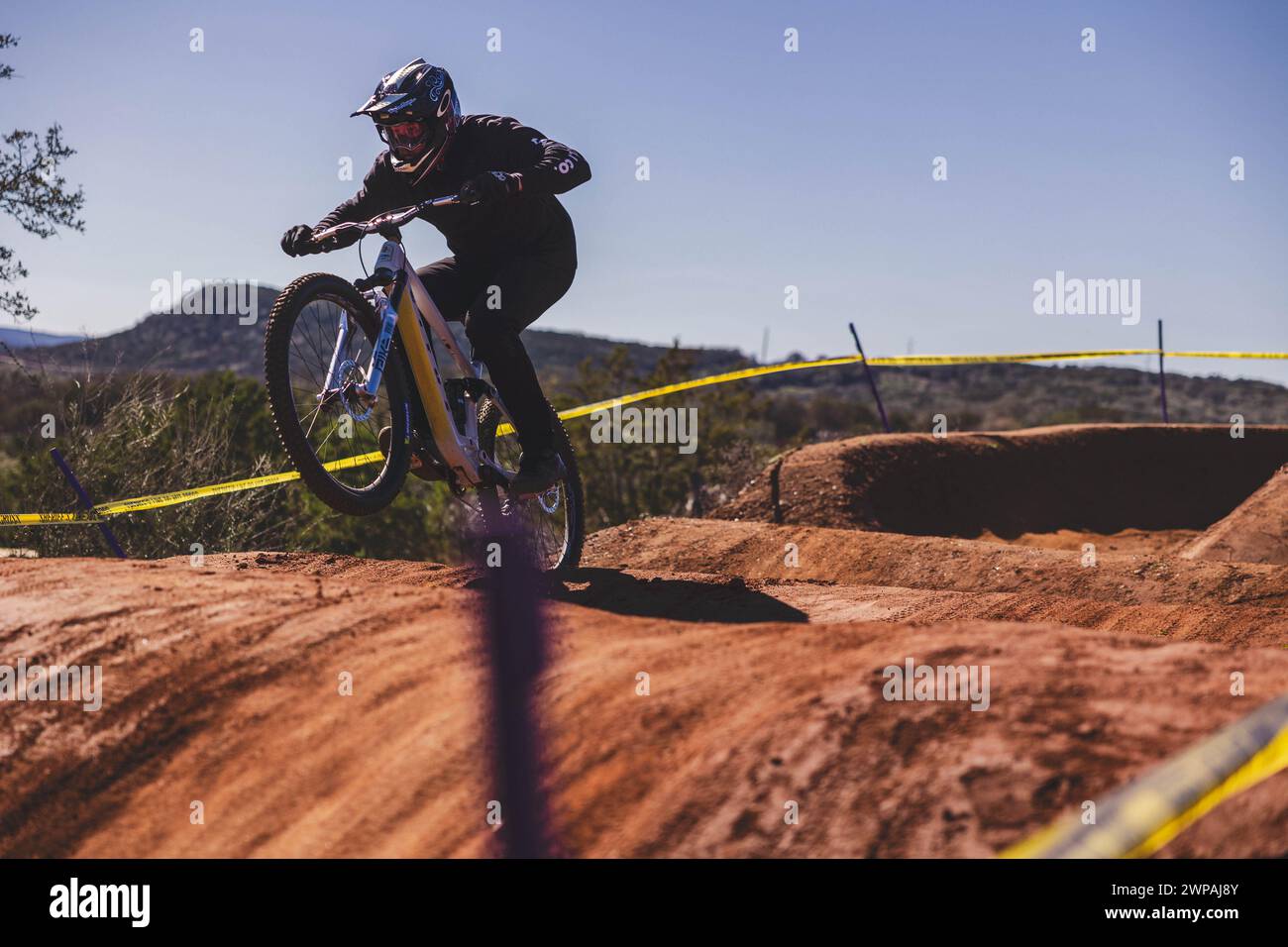 Mountain biker navigating a new muddy trail Stock Photo