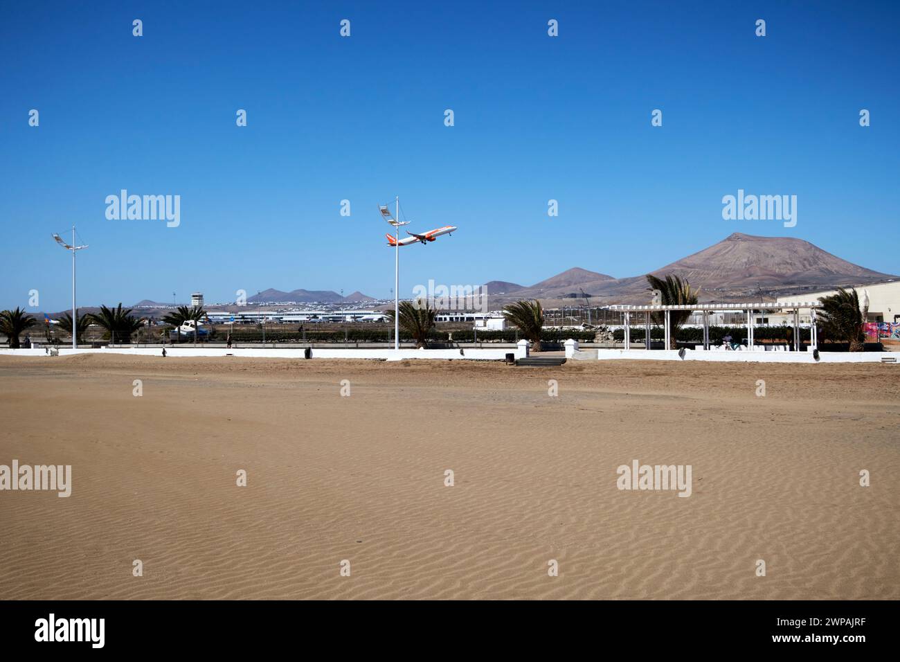 easyjet aircraft taking off over sandy playa honda beach looking towards lanzarote airport Playa Honda, Lanzarote, Canary Islands, spain Stock Photo