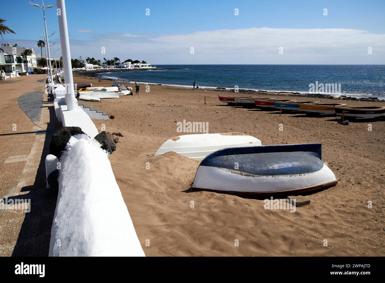 avenida playa honda and upside down wooden fishing boats Playa Honda, Lanzarote, Canary Islands, spain Stock Photo