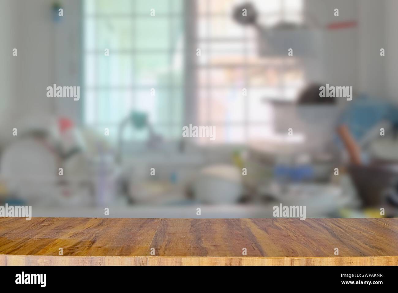 Empty wooden table top for place products and anything on blurred kitchen room background Stock Photo