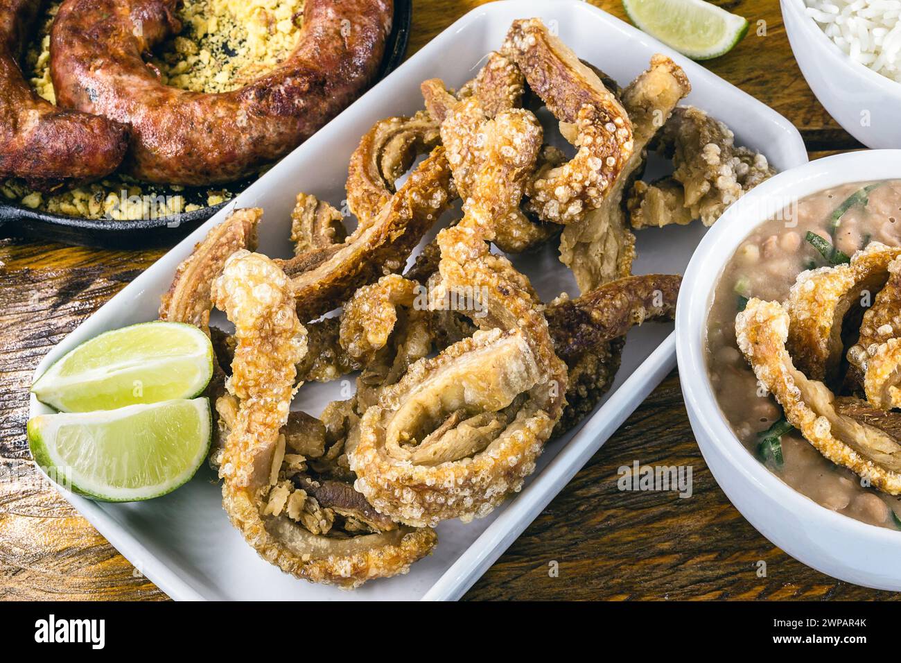 Typical food table in the interior of Brazil. Pork, beans, bean tutu, pork rinds, rice and farofa. Gastronomic tursimo concept, photo for restaurant m Stock Photo