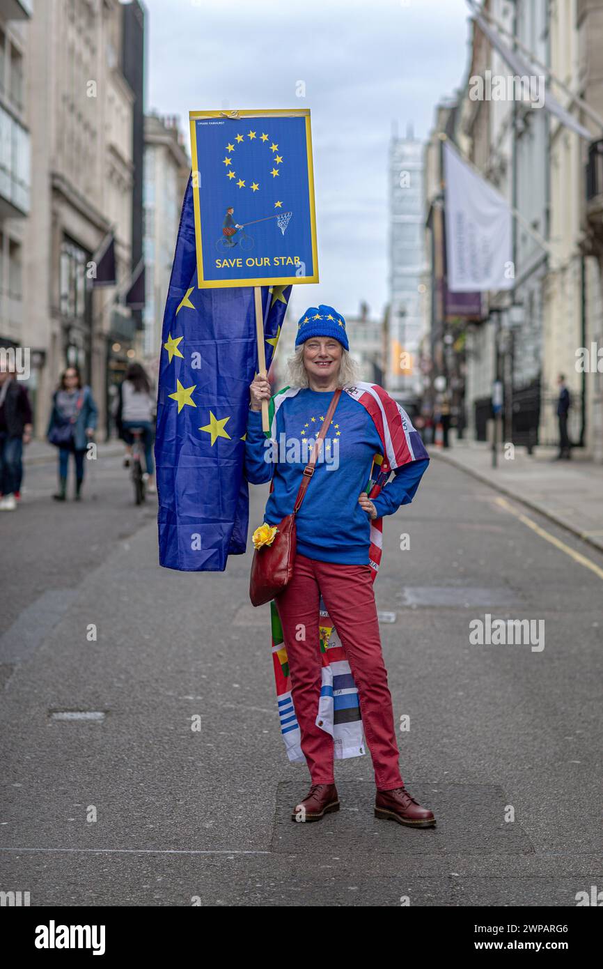 Female anti-brexit protester holds a 'save our star 'placard during Anti Brexit protest on March 23, 2019 in London. Stock Photo