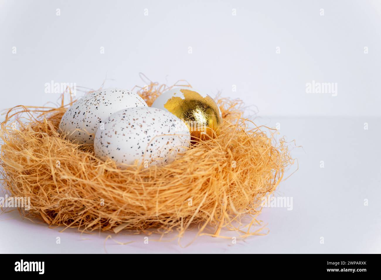 Nest with Easter eggs on white table. Selective focus. Stock Photo