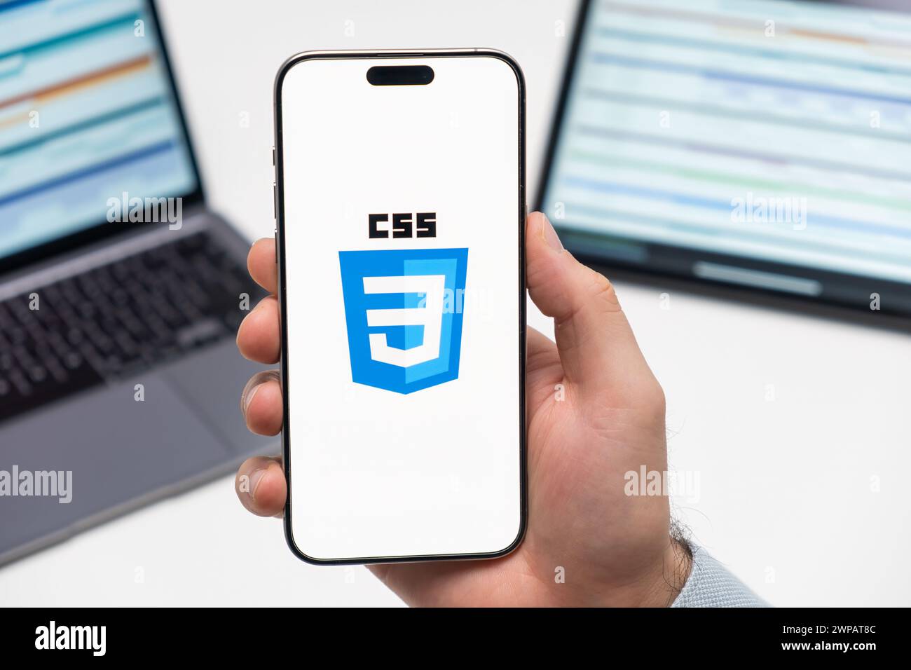 PRAGUE, CZECH REPUBLIC - JANUARY 21 2024: CSS logo on the screen of smartphone in mans hand on the workplace background.  Stock Photo