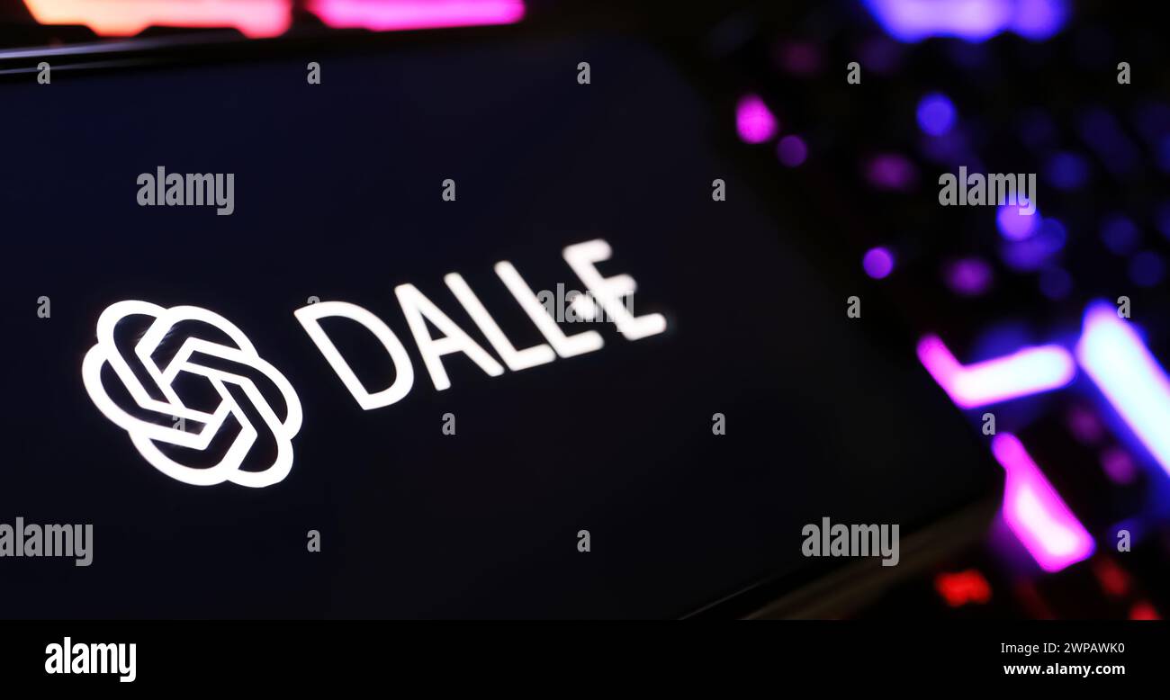 Viersen, Germany - February 9. 2024: Closeup of Smartphone screen with logo lettering of Open AI Dall-E image generator on computer keyboard Stock Photo