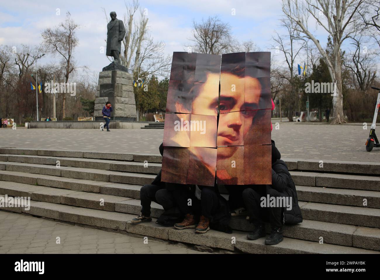 Students of the Odessa Higher Professional School of Trade and Food Technology put together a puzzle with the face of Taras Shevchenko against the background of the monument of the same name in the Central Park of Culture and Leisure named after Taras Grigorievich Shevchenko. Young patriots hold an event dedicated to the birthday of the famous Ukrainian poet. Taras Hryhorovych Shevchenko (9 March 1814 - 10 March 1861) was a Ukrainian poet, writer, artist, public and political figure, folklorist and ethnographer. He was a fellow of the Imperial Academy of Arts and a member of the Brotherhood of Stock Photo