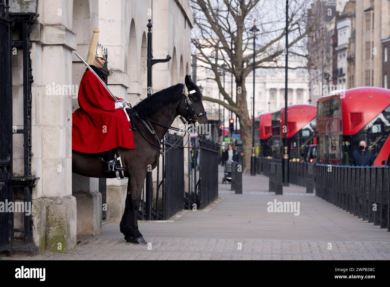Ceremonial parade of a mounted Horse Guard sentry on Whitehall, on 6th March 2024, in London, England. Two mounted sentries guard the entrance to Horse Guards on Whitehall from 10:00am until 4:00pm. The King’s Life Guard is conducted by soldiers of the Household Cavalry Mounted Regiment at Horse Guards. Horse Guards is named after the troops who have mounted The King’s Life Guard here since the Restoration of King Charles II in 1660. Stock Photo