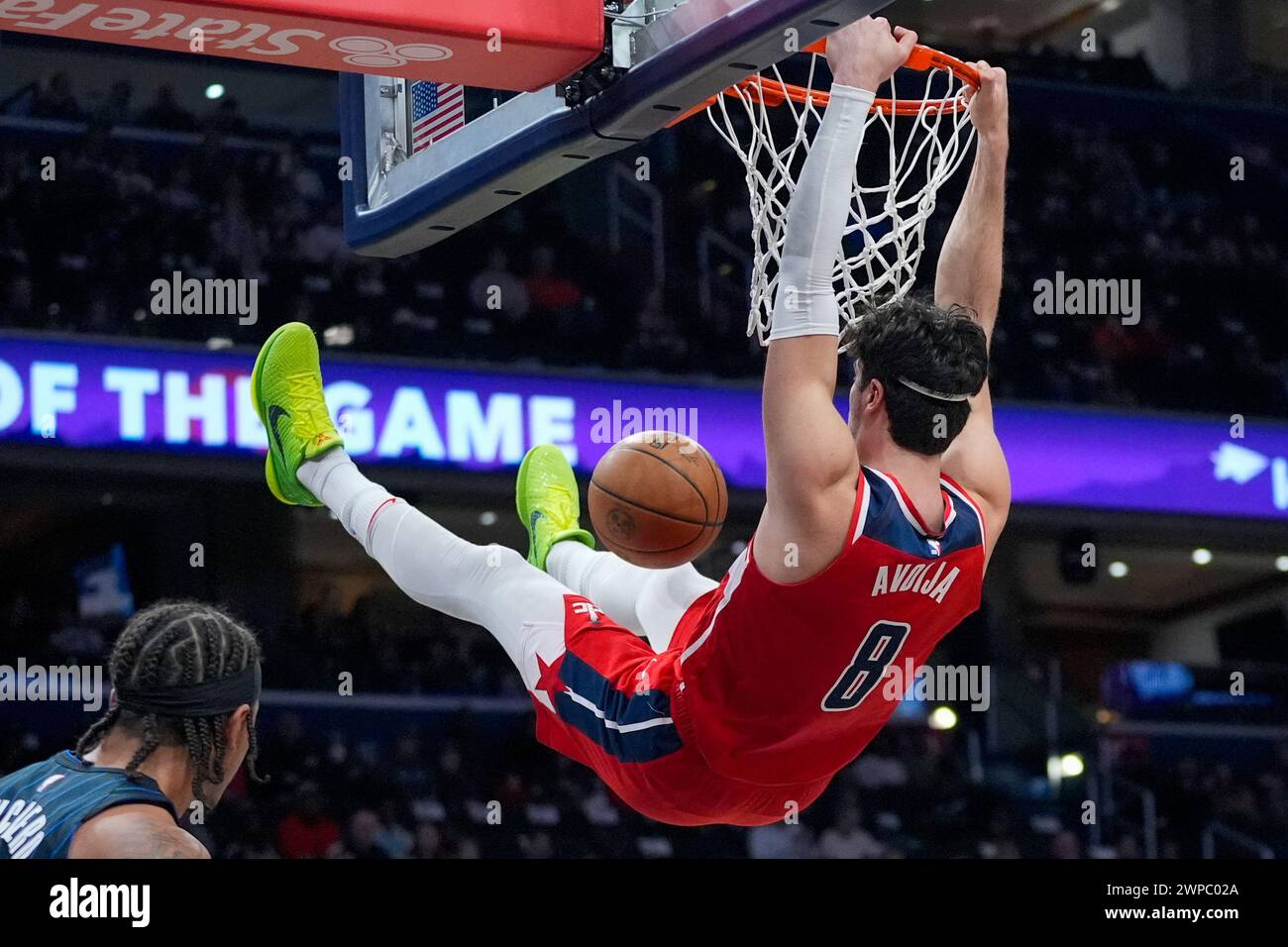 Washington Wizards forward Deni Avdija hangs from the rim after a dunk ...