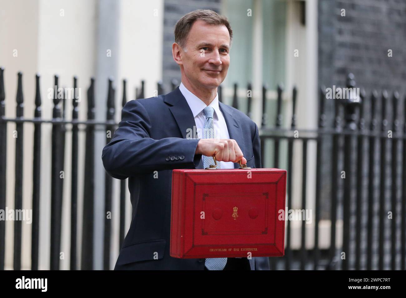 Beijing, China. 7th Mar, 2024. The United Kingdom's (UK) Chancellor of the Exchequer Jeremy Hunt poses for photographs as he leaves 11 Downing Street to deliver his budget to Parliament in London, Britain, on March 6, 2024. The United Kingdom's (UK) Chancellor of the Exchequer Jeremy Hunt on Wednesday announced in his spring budget that National Insurance contributions would be cut for 27 million British workers. Credit: Xinhua/Alamy Live News Stock Photo