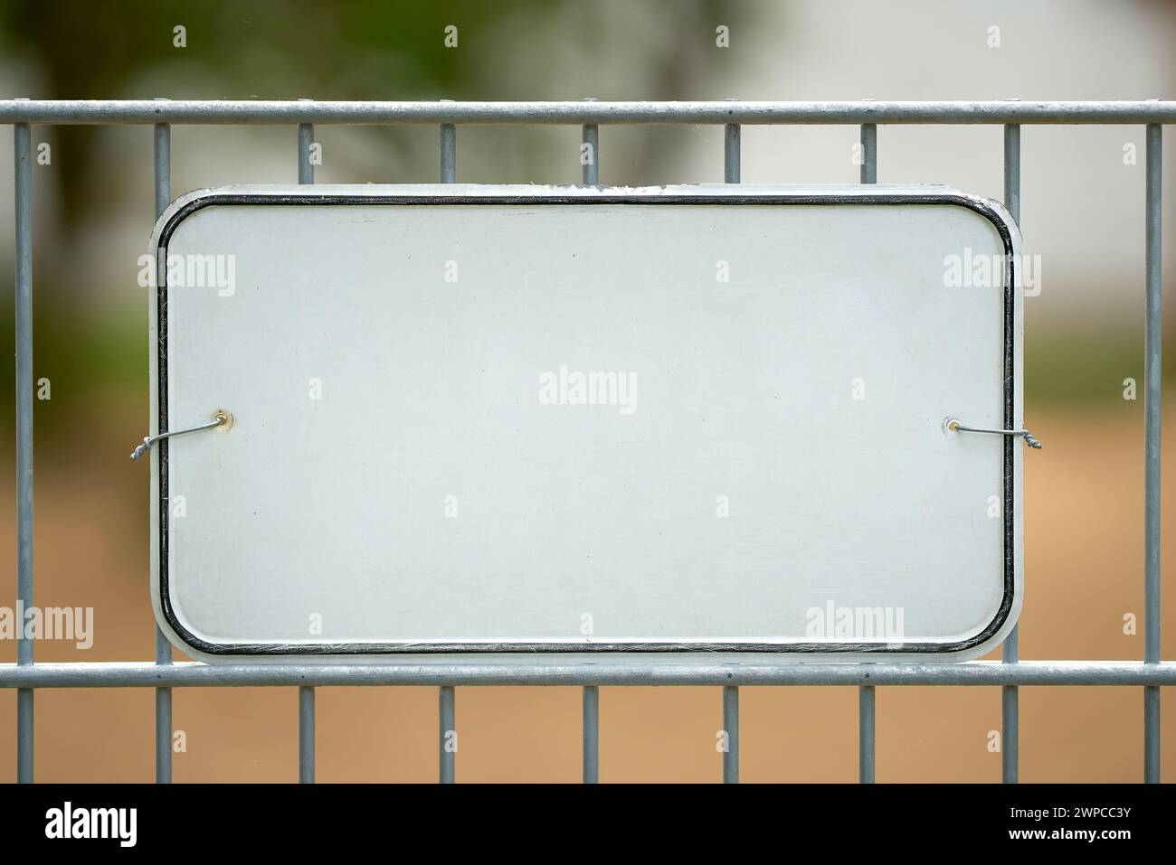 White unmarked sign on a fence with space for text Stock Photo