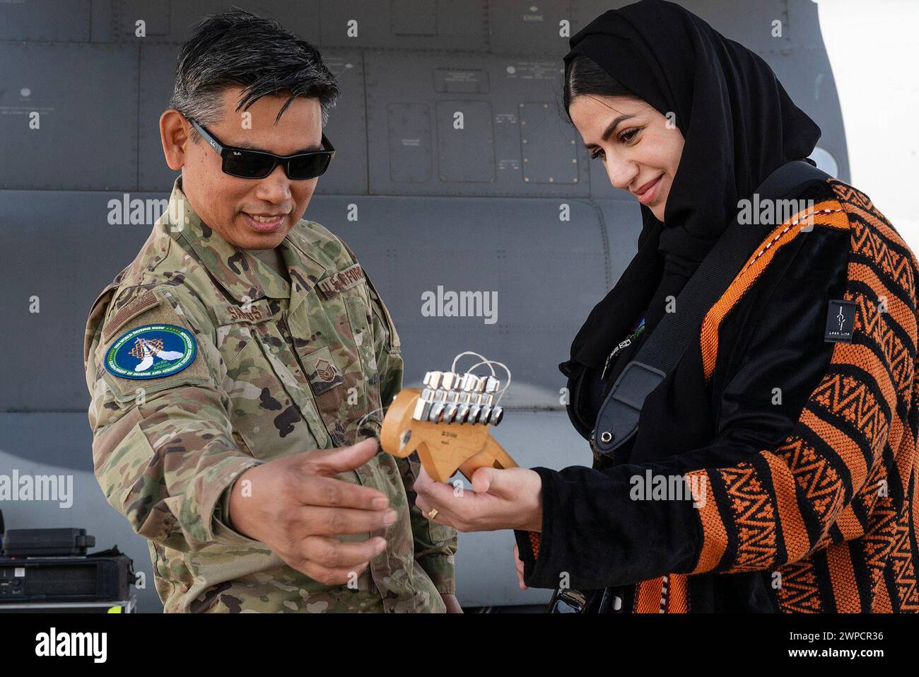 Saudi Arabia. 7th Feb, 2024. An Airman assigned to the U.S. Air Forces Central Band instructs a show attendee how to play a guitar during the Saudi World Defense Show near Riyadh. The AFCENT Band travels throughout Central and Southwest Asia performing community outreach concerts, school assemblies, military functions, troop morale concerts, and diplomatic events hosted by the USA Embassies and their ambassadors. Saudi Arabias WDS 2024, one of the regions largest defense expositions, includes a wide array of aircraft and assets from across the U.S. Department of Defense. (Credit Image: © Stock Photo
