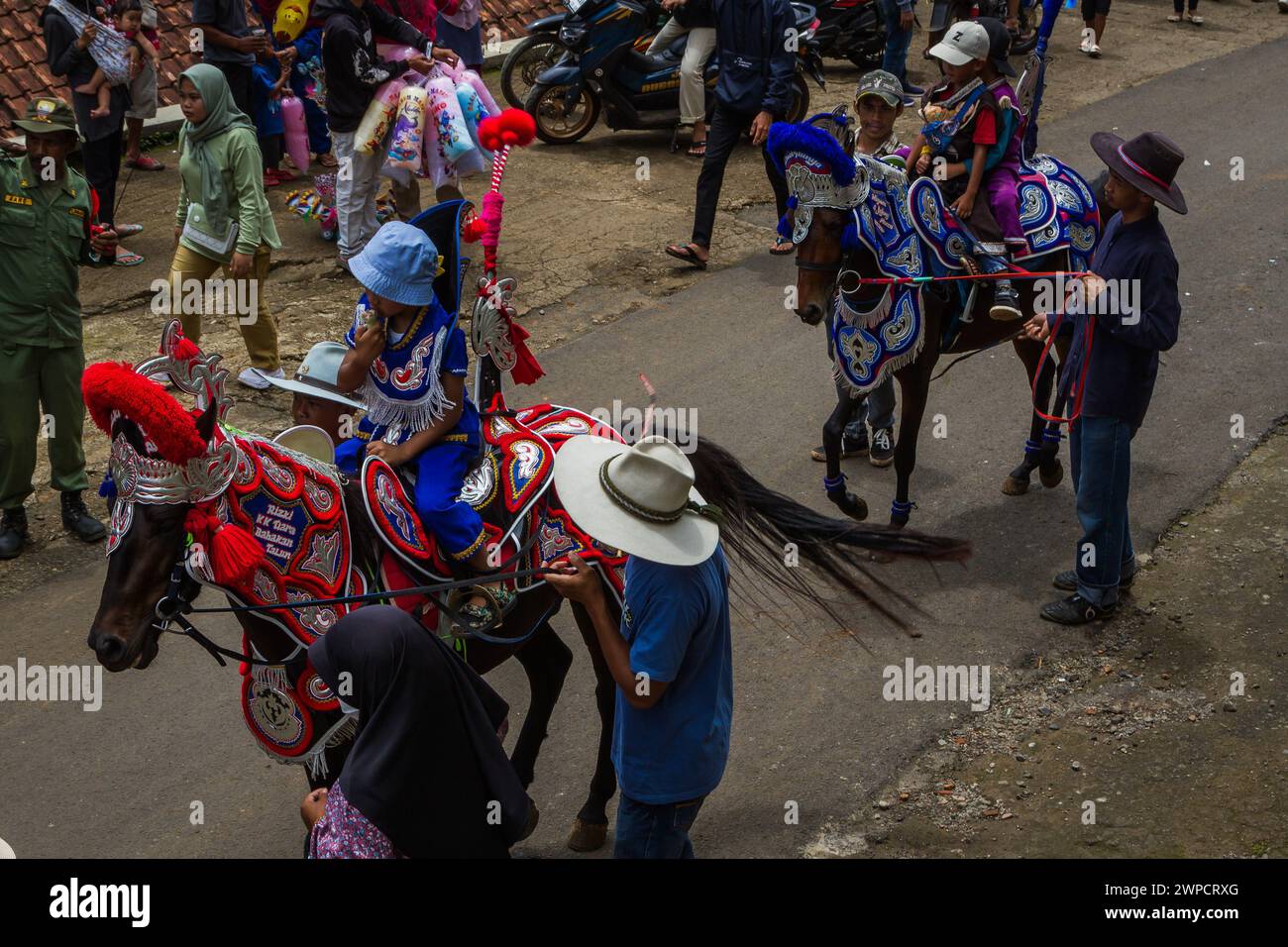 Sumedang, West Java, Indonesia. 7th Mar, 2024. Children ride a dancing horse during performance in Tanjungsari, Sumedang Regency. Dancing Horse, also known as ''Kuda Renggong'', is one of Sumedang's traditional and cultural performing arts. The word ''renggong'' comes from the Sundanese ''ronggeng'' or ''kamonesan'' meaning skill. The renggong horse has been trained in its skills to be able to dance according to the accompaniment of traditional Sundanese music. (Credit Image: © Algi Febri Sugita/ZUMA Press Wire) EDITORIAL USAGE ONLY! Not for Commercial USAGE! Stock Photo