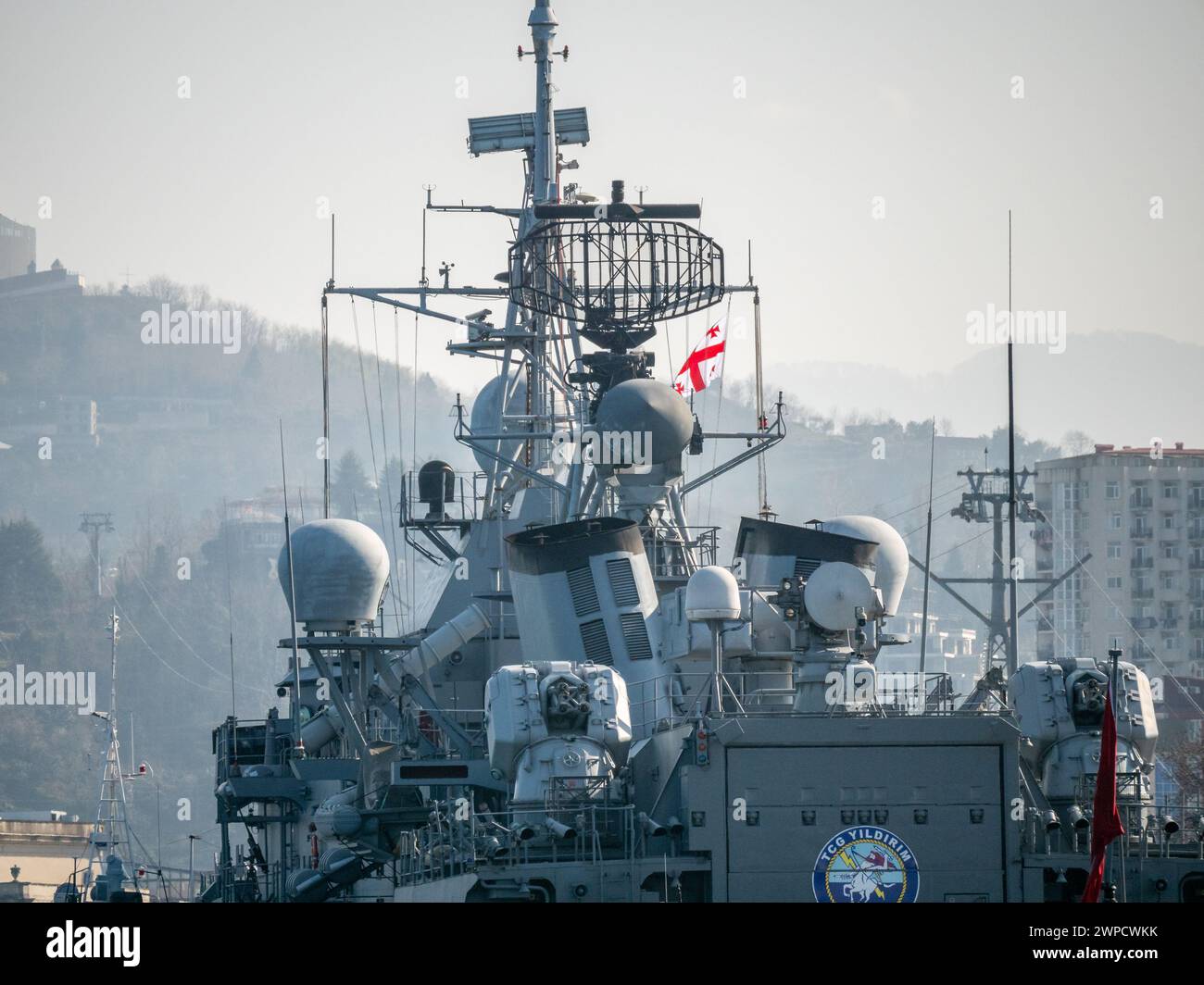 Detailed view of Georgian Flag on Turkish Navy warship superstructure featuring radar equipment and antennas - Batumi, Georgia - 05 March 2024. Stock Photo