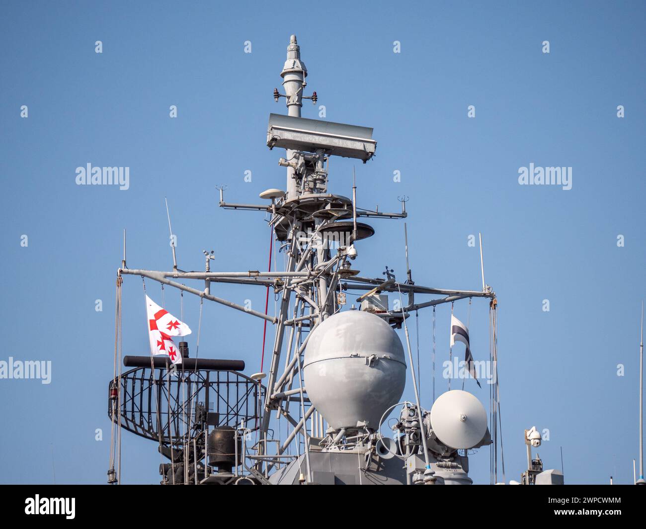 Detailed view of Georgian Flag on Turkish Navy warship superstructure featuring radar equipment and antennas - Batumi, Georgia - 05 March 2024. Stock Photo