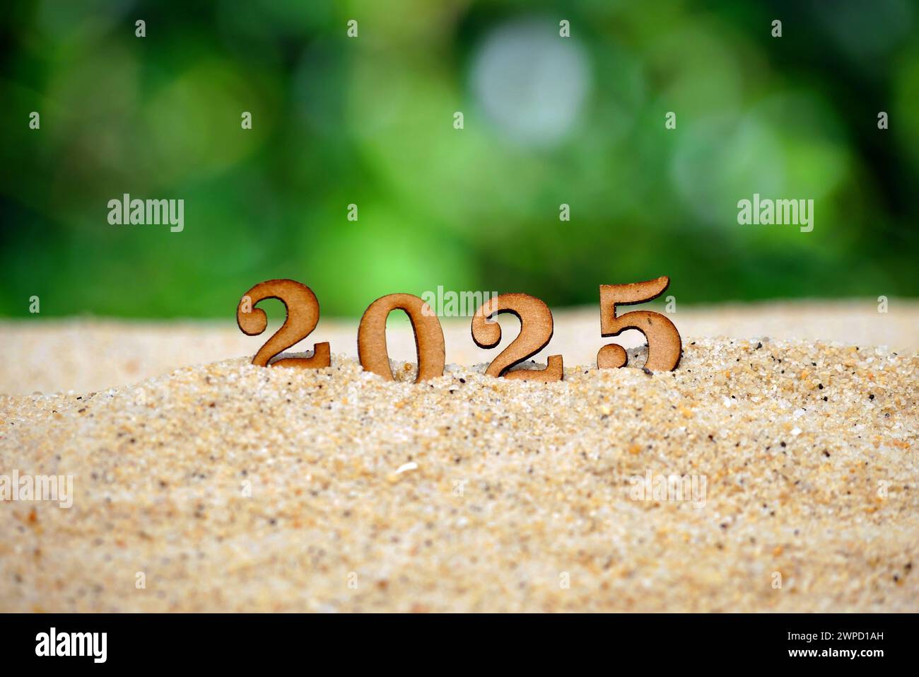2025 background on beach sand with bokeh nature background Stock Photo