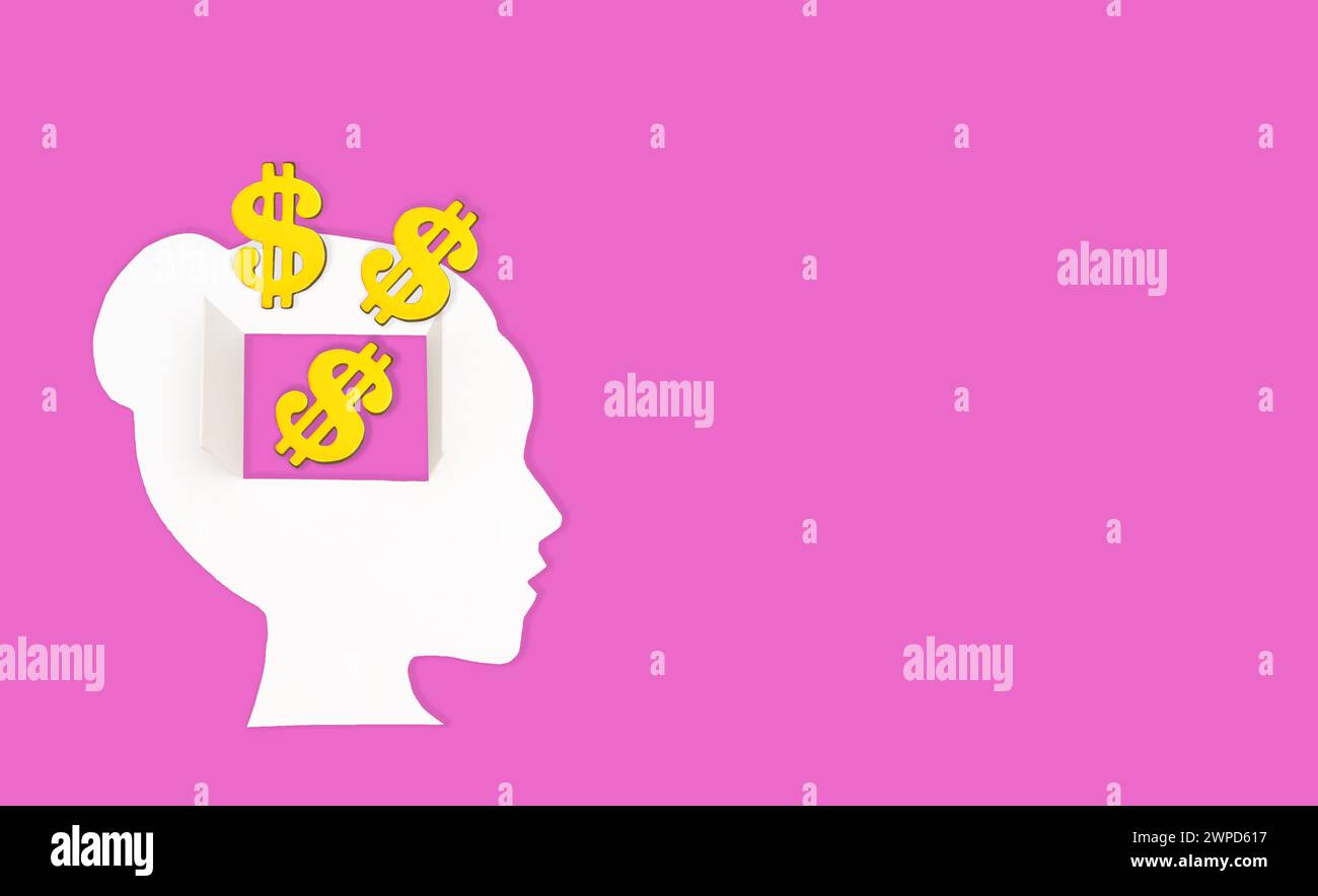 Female paper head isolated on pink background. Golden dollar signs spill through the open window in the brain area. Mindful spending habits concept. Stock Photo