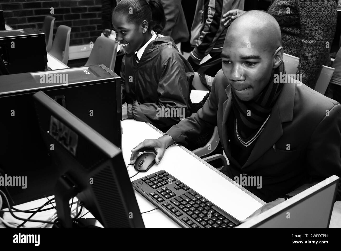 A monochrome shot of individuals at work on computers in Johannesburg, South Africa Stock Photo