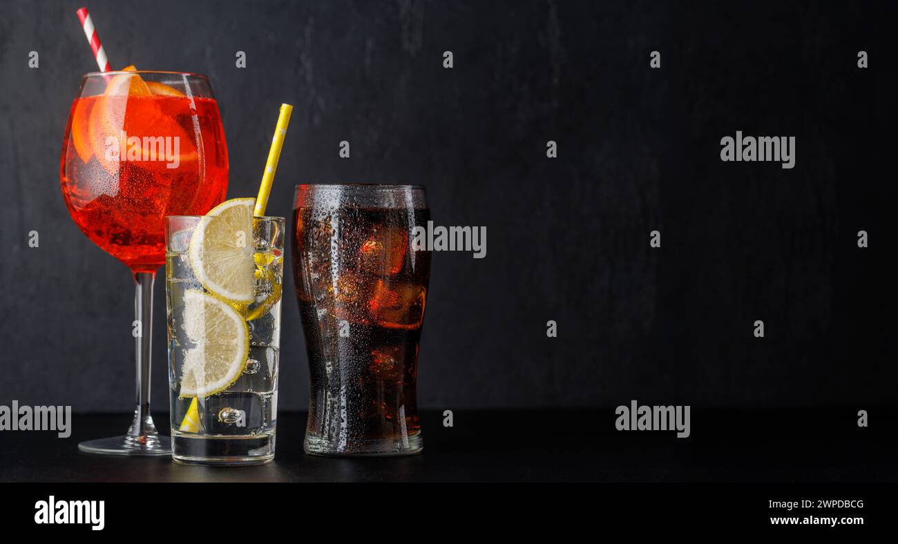 Aperol spritz, cola and gin tonic cocktails on black with copy space Stock Photo Alamy