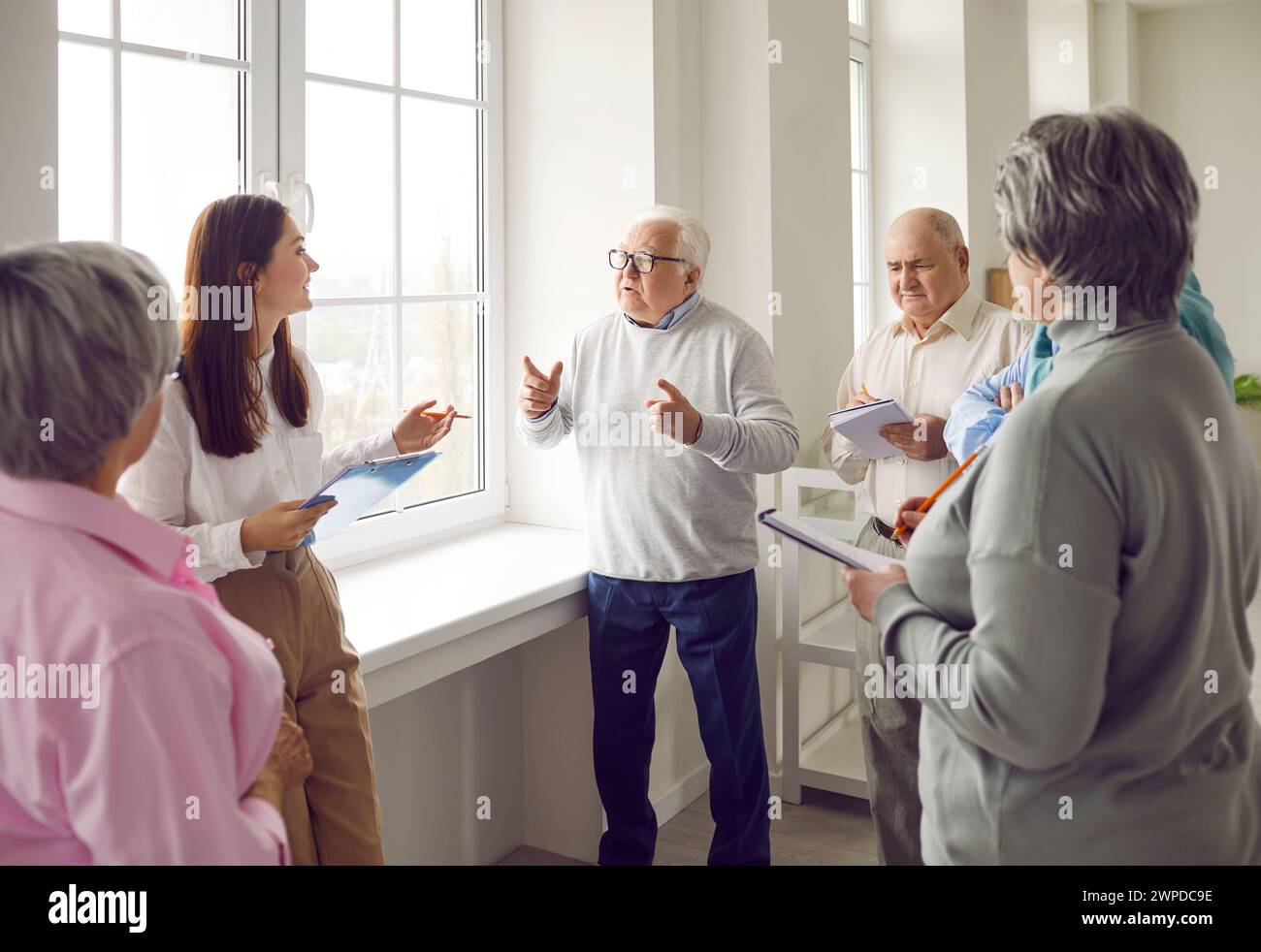 Group of senior men and women meeting and communicating with a therapist and psychologist Stock Photo