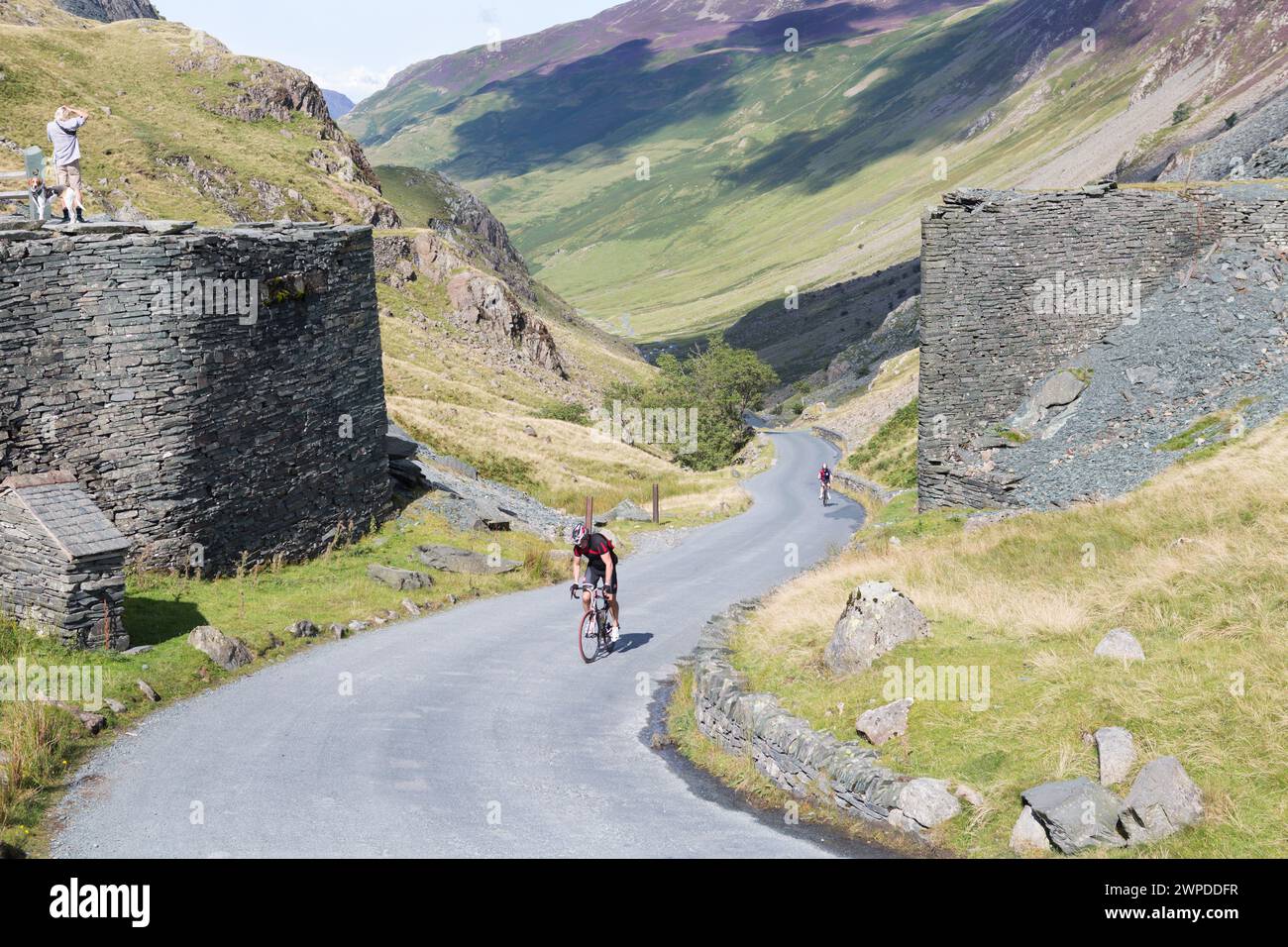 UK, Cumbria, Honnister Pass, cyclists ascending Honnister Pass, one of the UK's steepest roads. Stock Photo